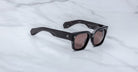 Jacques Marie Mage Enzo sunglasses, bold black rectangular frames with thick temples and dark lenses, shown from the front angle.