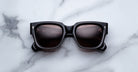 Jacques Marie Mage Enzo black rectangular sunglasses with UV protection, top view.