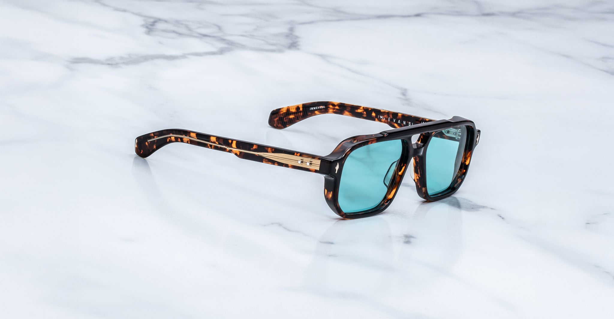 Jacques Marie Mage Evans sunglasses with blue lenses, top view, product on display.