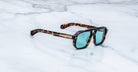 Jacques Marie Mage Evans sunglasses with blue lenses, top view, product on display.
