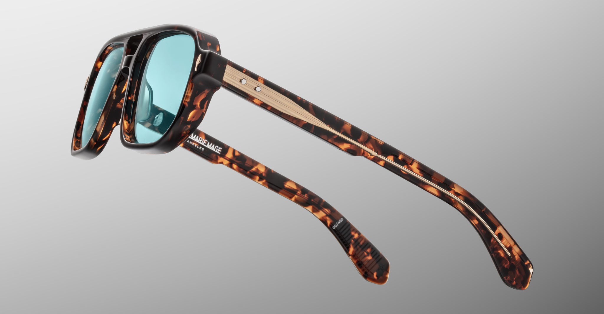 Jacques Marie Mage Evans tortoiseshell sunglasses with blue lenses and wood accents, shown from the front.