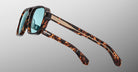 Jacques Marie Mage Evans tortoiseshell sunglasses with blue lenses and wood accents, shown from the front.
