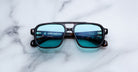 Jacques Marie Mage Evans sunglasses with blue lenses and black frames, shown from the front.