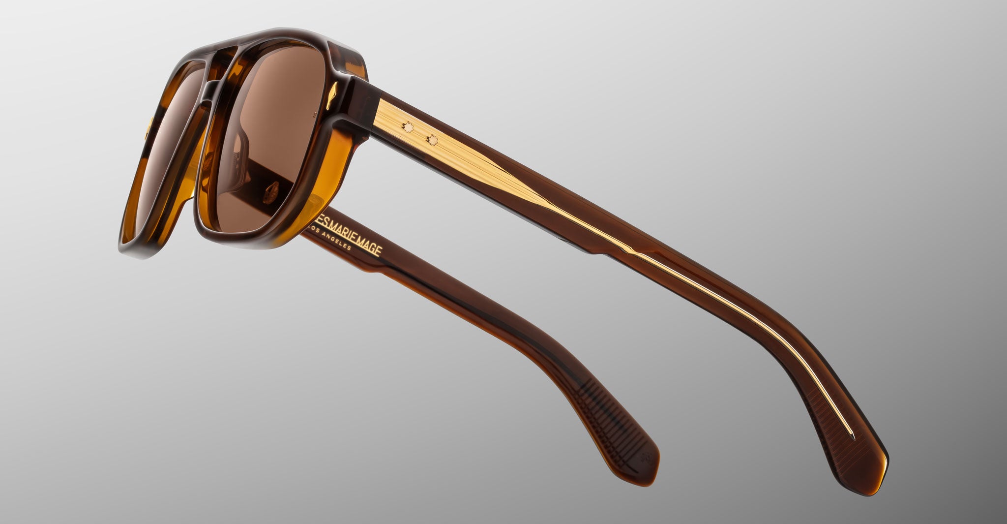 Jacques Marie Mage Evans sunglasses, angular brown frames with gold accents and tinted lenses, front view.