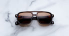 Jacques Marie Mage Evans black rectangular sunglasses with UV-protective lenses, shown from above.