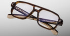 The Jacques Marie Mage Evans features handcrafted oversized acetate frames with brown tortoiseshell rectangular lenses, displayed against a neutral background.