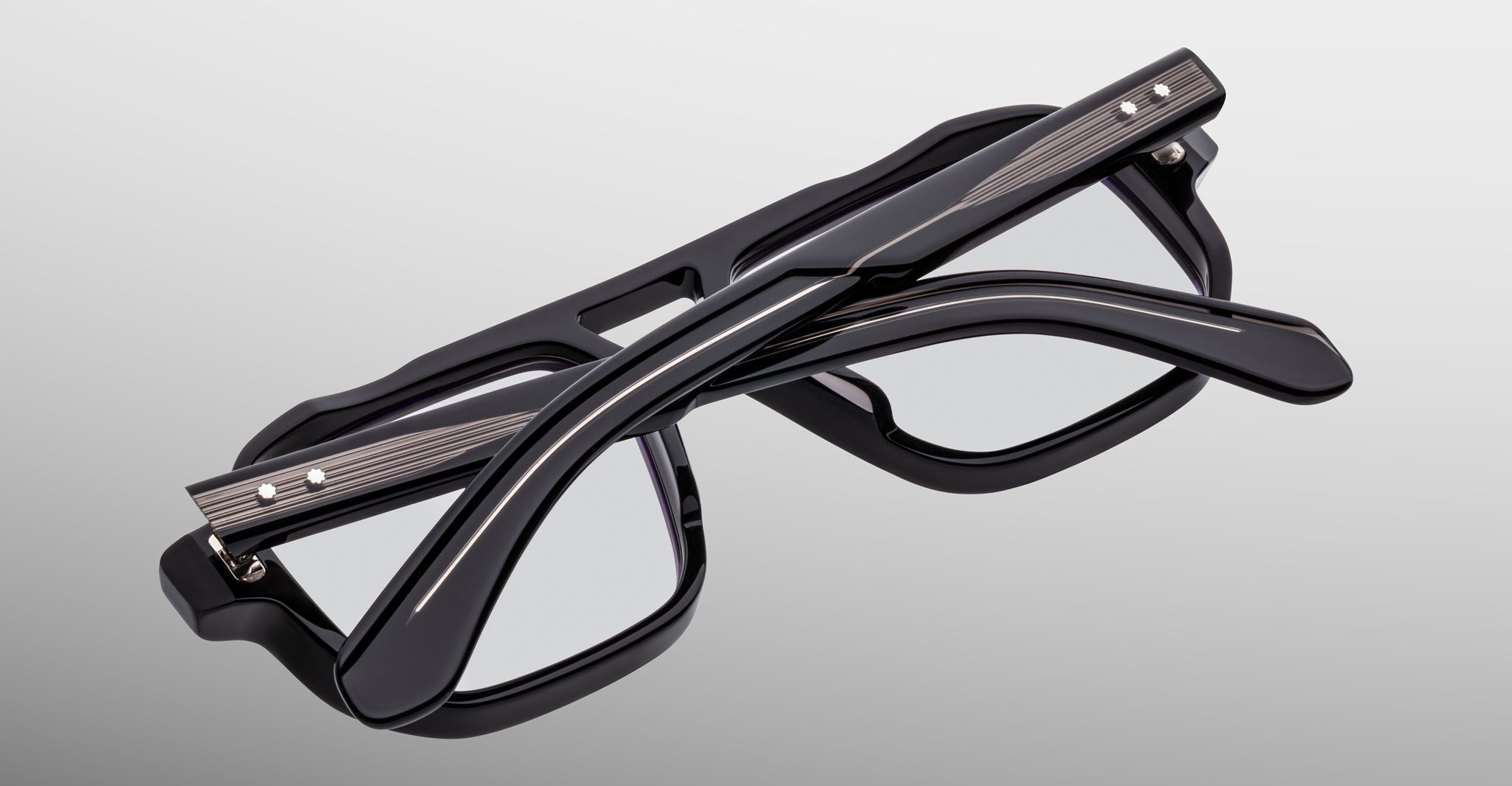The Jacques Marie Mage Evans, a pair of black handcrafted optical glasses with rectangular frames, is shown folded against a plain light background.