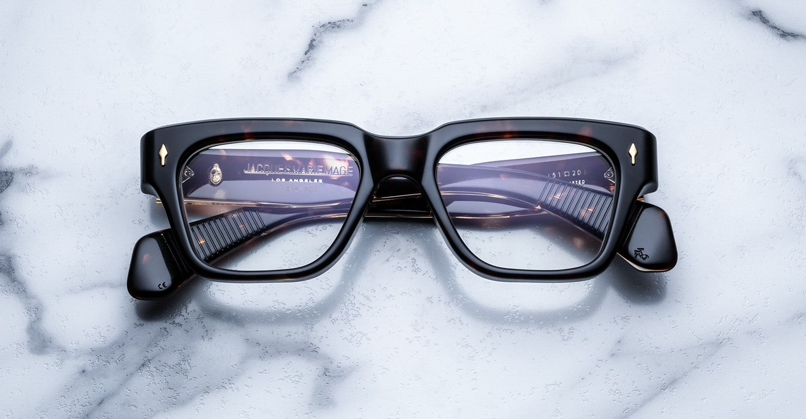 Jacques Marie Mage Fellini square tortoiseshell eyeglasses with folded arms viewed from above.