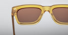 Close-up of Jacques Marie Mage Fellini sunglasses featuring yellow square frames and brown tinted lenses, viewed from the front.