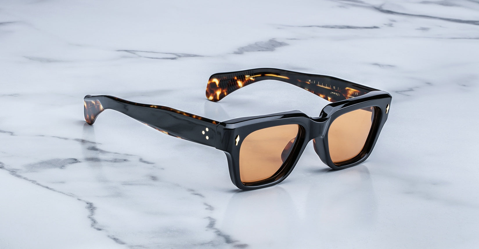 Jacques Marie Mage Fellini sunglasses, black square frames, brown lenses, tortoise arms, shown from above.