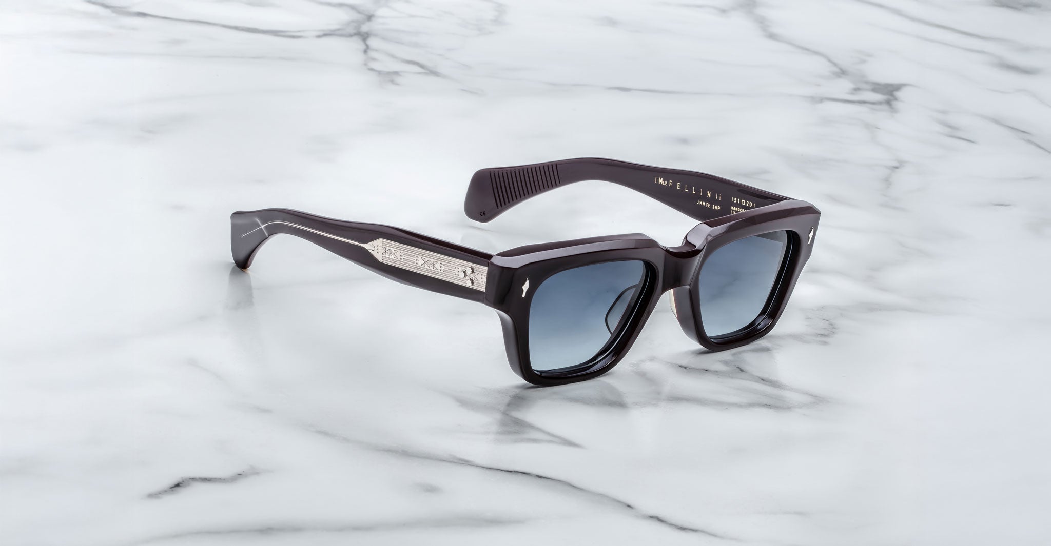 Jacques Marie Mage Fellini black square-framed polarized sunglasses with dark lenses, top-down angle.