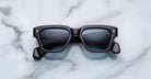 Jacques Marie Mage Fellini black rectangular sunglasses with dark lenses, front-facing view.