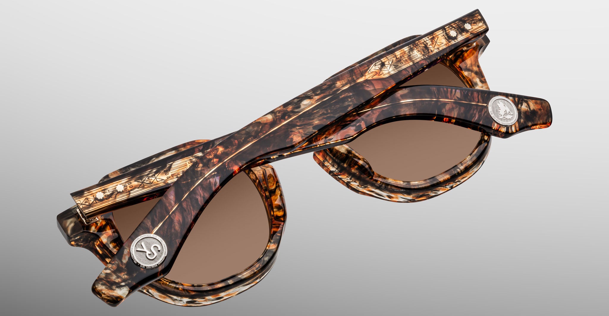 Jacques Marie Mage Firehole River tortoiseshell folding sunglasses, round lenses, silver hinge emblems, shown closed.