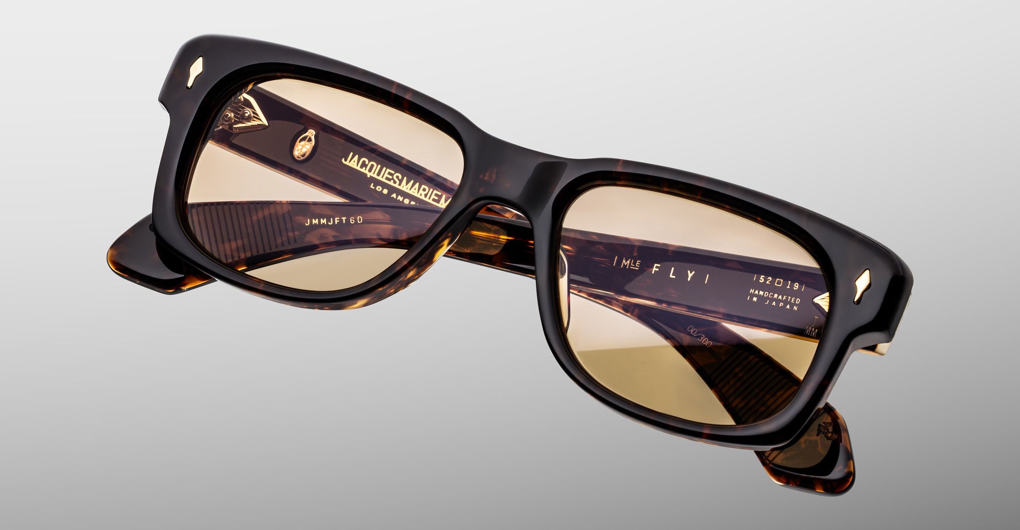 Jacques Marie Mage Fly sunglasses, square brown tortoiseshell frame, light brown lenses, visible inner-arm logos.