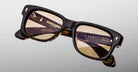 Jacques Marie Mage Fly sunglasses, square brown tortoiseshell frame, light brown lenses, visible inner-arm logos.