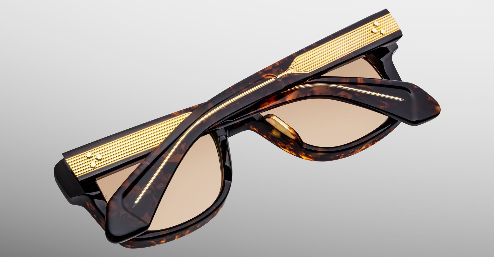 Jacques Marie Mage Fly sunglasses, folded, with gold-accented temples, side view.