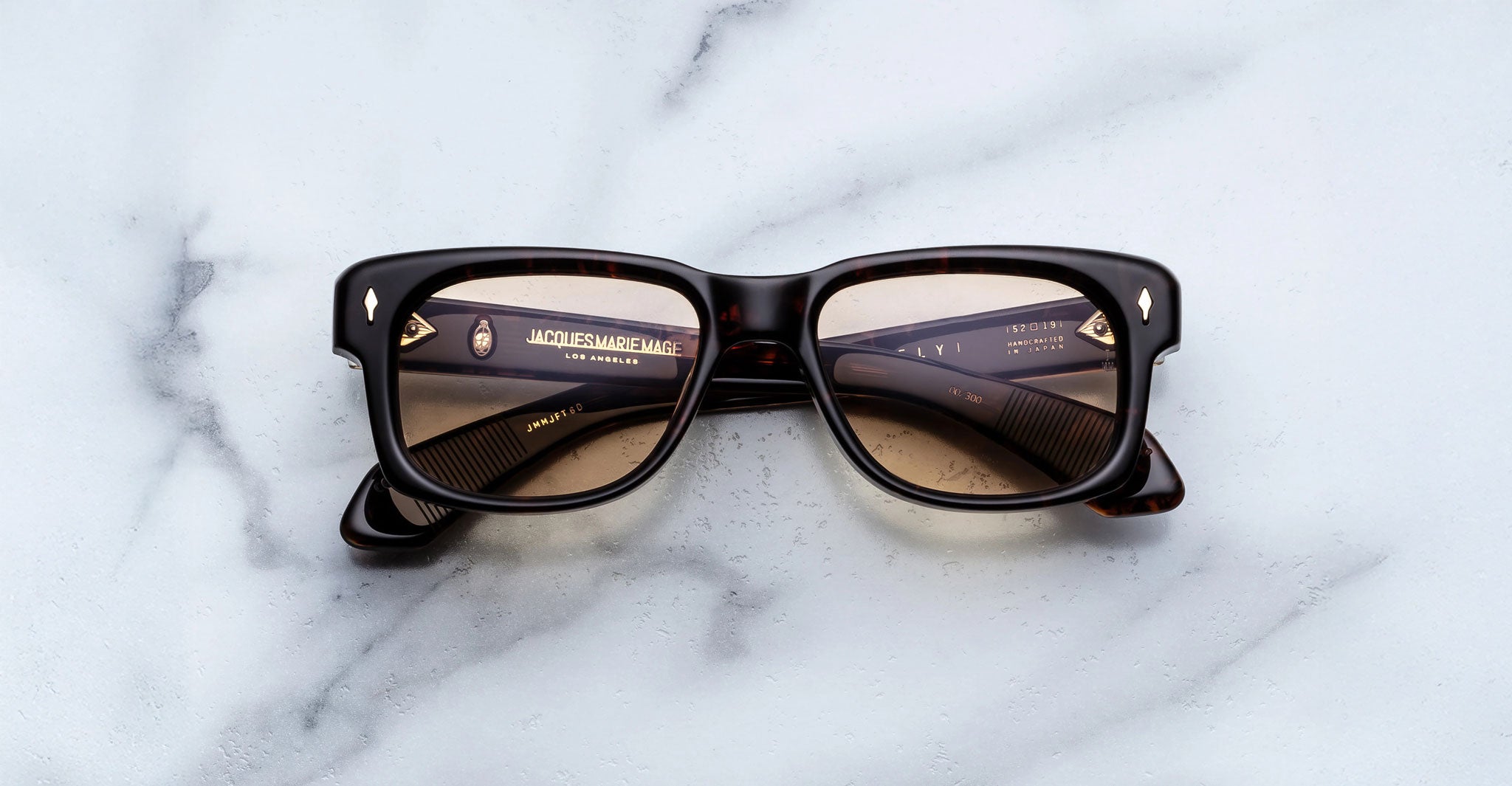 Jacques Marie Mage Fly square sunglasses viewed from above, showing front and temples of the eyewear.
