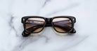 Jacques Marie Mage Fly square sunglasses viewed from above, showing front and temples of the eyewear.