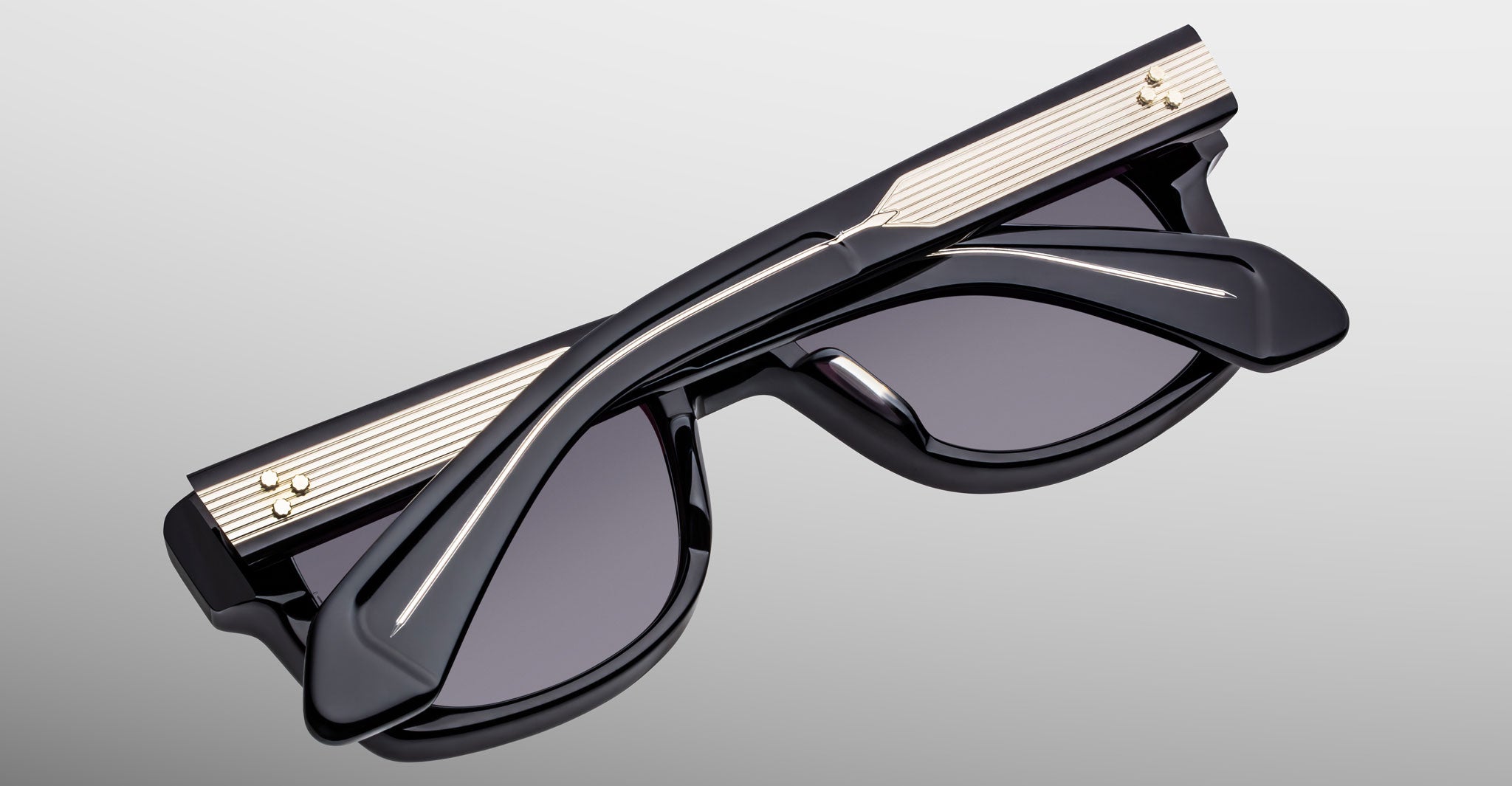 Jacques Marie Mage Fly sunglasses, folded with gold accents, top view showing frame details.