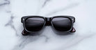 Jacques Marie Mage Fly sunglasses with dark lenses and bold rectangular frames, front view.