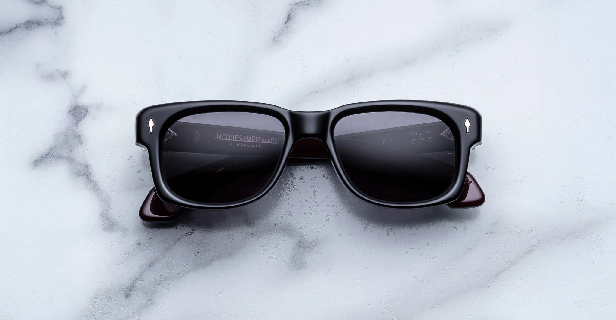 Jacques Marie Mage Fly sunglasses with dark lenses and bold rectangular frames, front view.