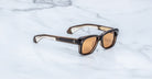 Jacques Marie Mage Fly sunglasses, black-beige frames, brown lenses, top view.