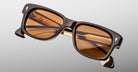 Jacques Marie Mage Fly sunglasses, brown rectangular frame with amber polarized lenses, front view.