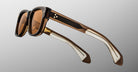 Jacques Marie Mage Fly sunglasses, front view, thick brown acetate frames, metal accents, two studs, gradient lenses.