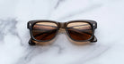 Jacques Marie Mage Fly rectangular brown sunglasses with polarized dark lenses, top view.