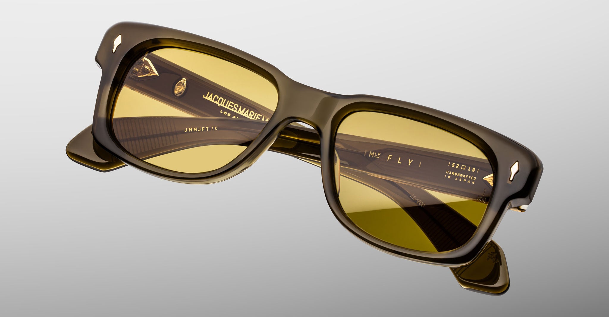 Jacques Marie Mage Fly rectangular sunglasses, thick olive-green frame, yellow lenses, front view.