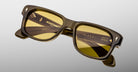 Jacques Marie Mage Fly rectangular sunglasses, thick olive-green frame, yellow lenses, front view.