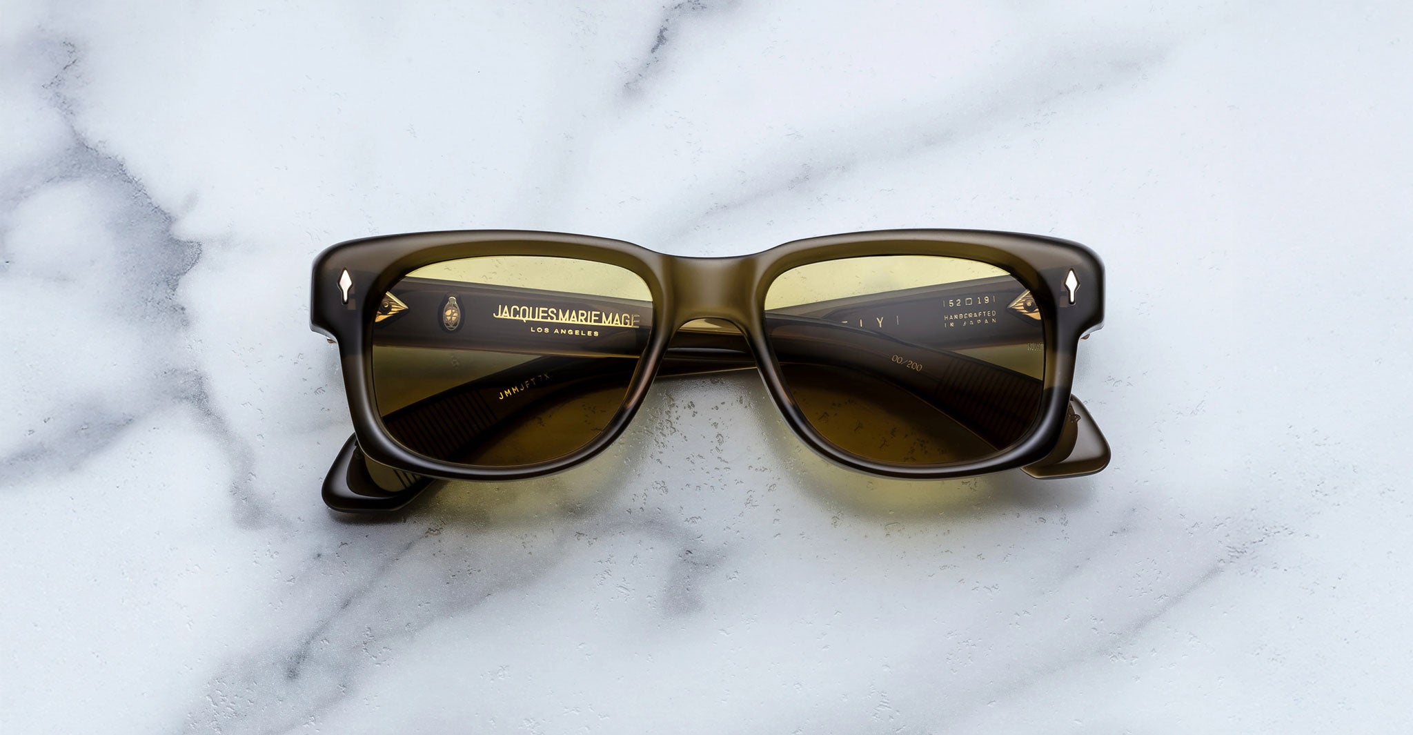 Jacques Marie Mage Fly sunglasses, thick black rims, dark lenses, front view.