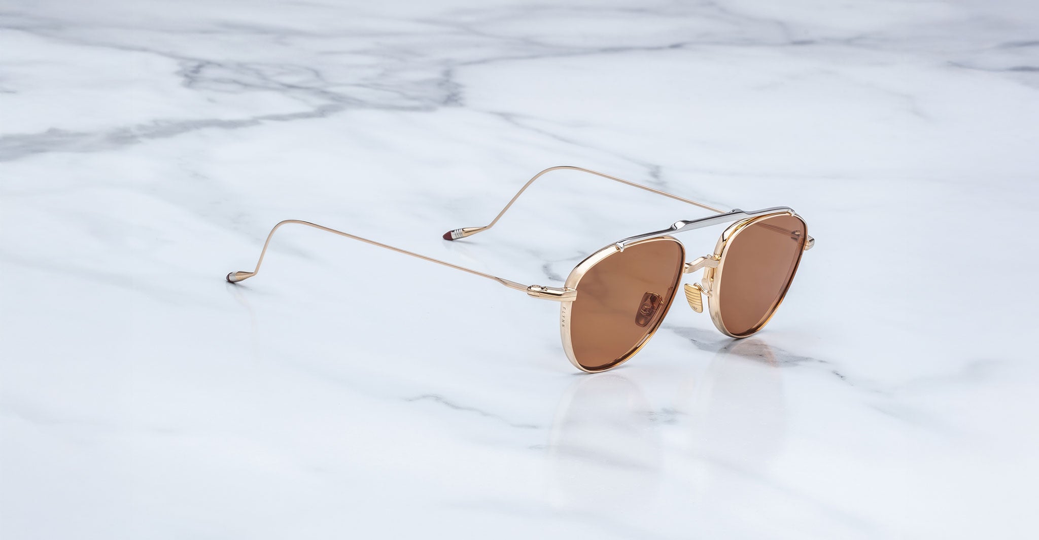Jacques Marie Mage Flynn aviator sunglasses with gold frames and brown lenses, front view.