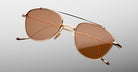 Jacques Marie Mage Flynn gold aviator sunglasses with brown lenses, front angle view.