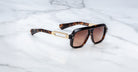 Jacques Marie Mage Fugue sunglasses with gold accents and UV lenses, top view, designer eyewear by Jacques Marie Mage.