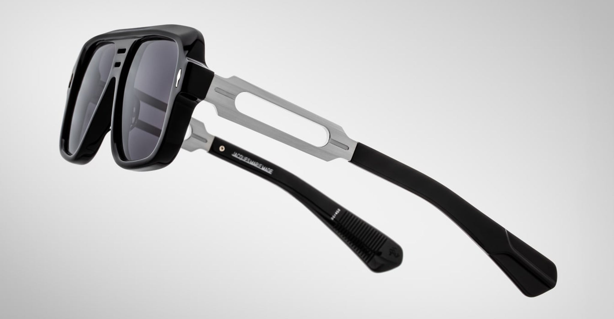 Jacques Marie Mage Fugue sunglasses with thick black frames and silver temples, front view, designer eyewear by Jacques Marie Mage.