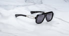 Jacques Marie Mage Fugue sunglasses with silver accents and UV lenses, top-down view.