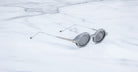 Jacques Marie Mage Balthazar sunglasses with slim metal arms, viewed from above, on display.