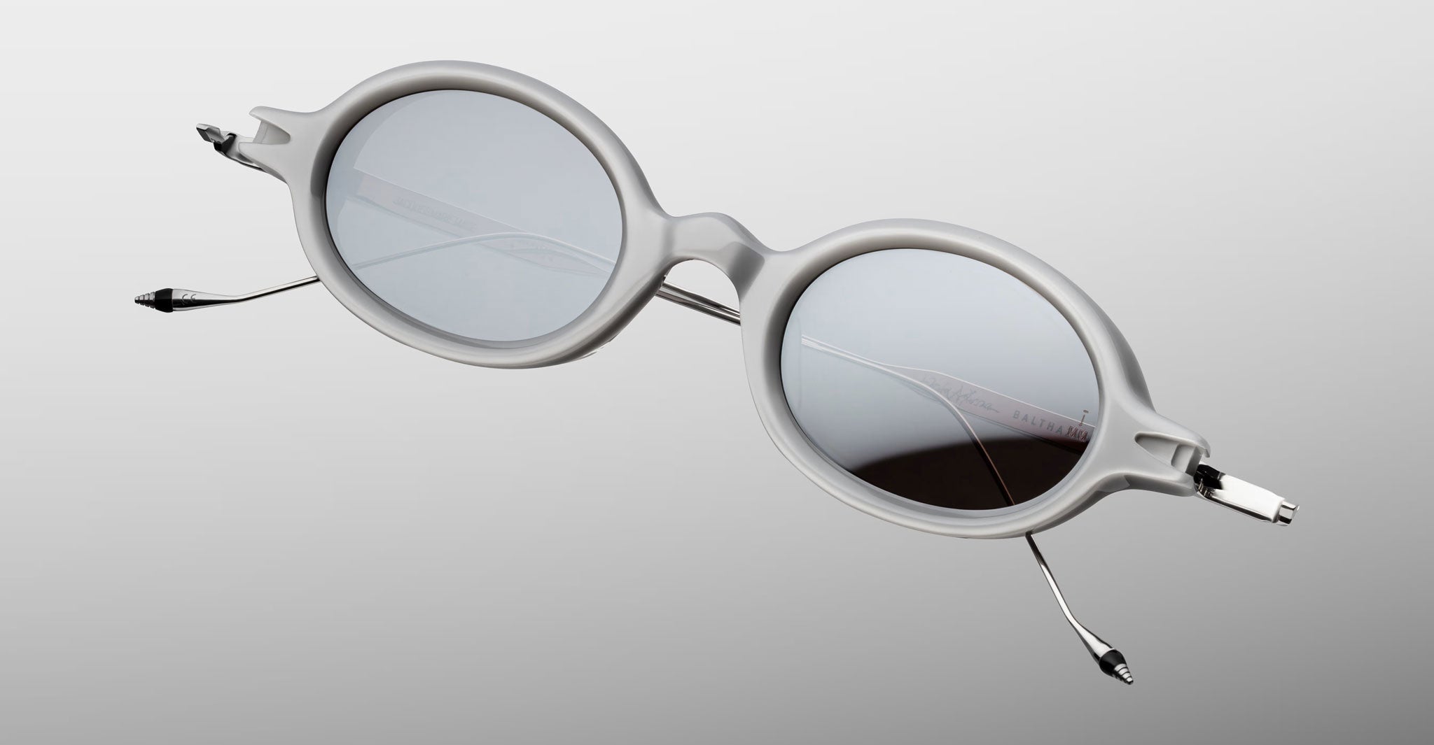 Jacques Marie Mage Balthazar round sunglasses with thick light gray frames and silver metal arms, front-facing view.