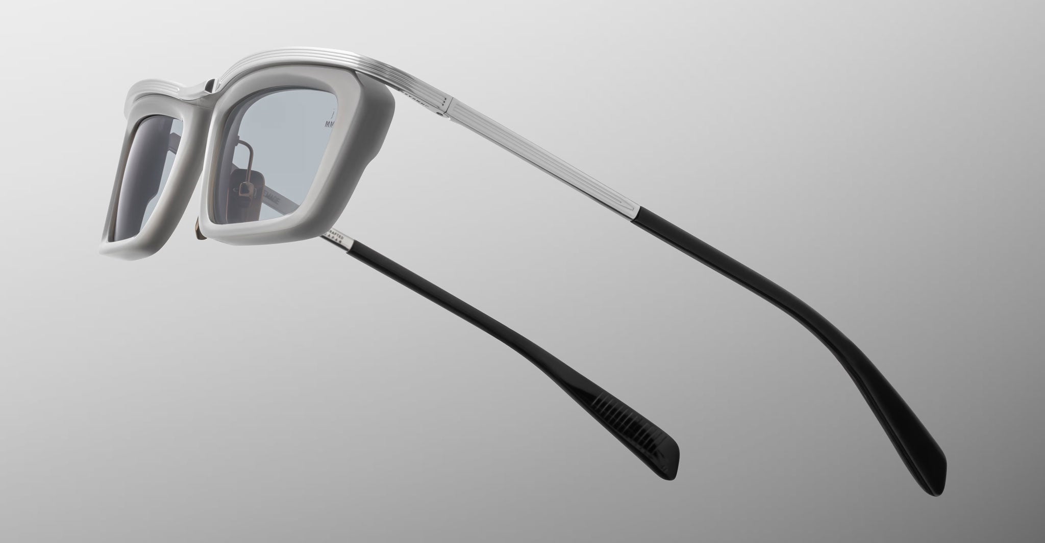 Jacques Marie Mage Gaspard eyeglasses, rectangular gray frames with black tips, front view.