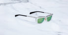 Jacques Marie Mage Gaspard square sunglasses, clear frames, green lenses, black arms, shown from the front.