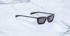 Jacques Marie Mage Gaspard black rectangular sunglasses with UV-protective lenses, shown from above.
