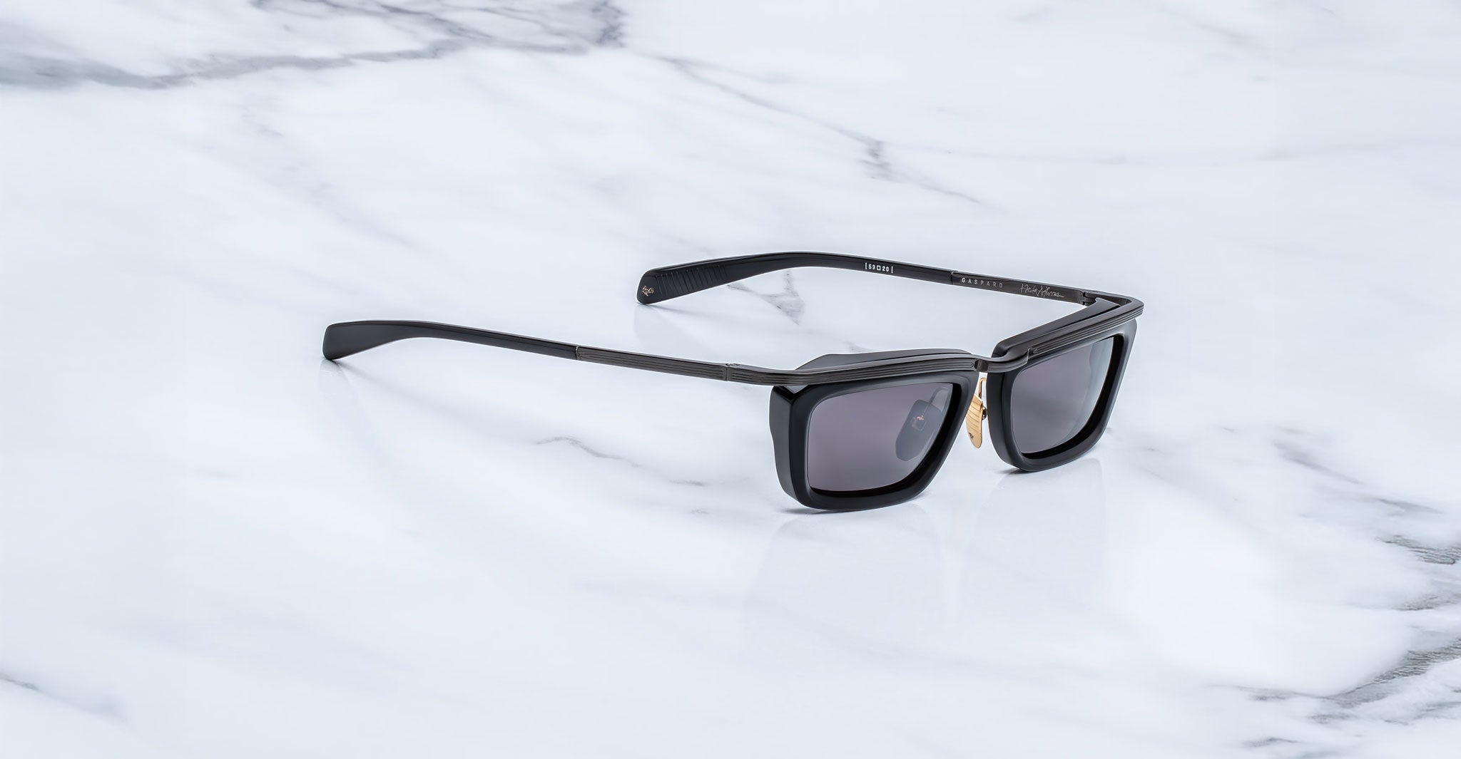 Jacques Marie Mage Gaspard black rectangular sunglasses with UV-protective lenses, shown from above.