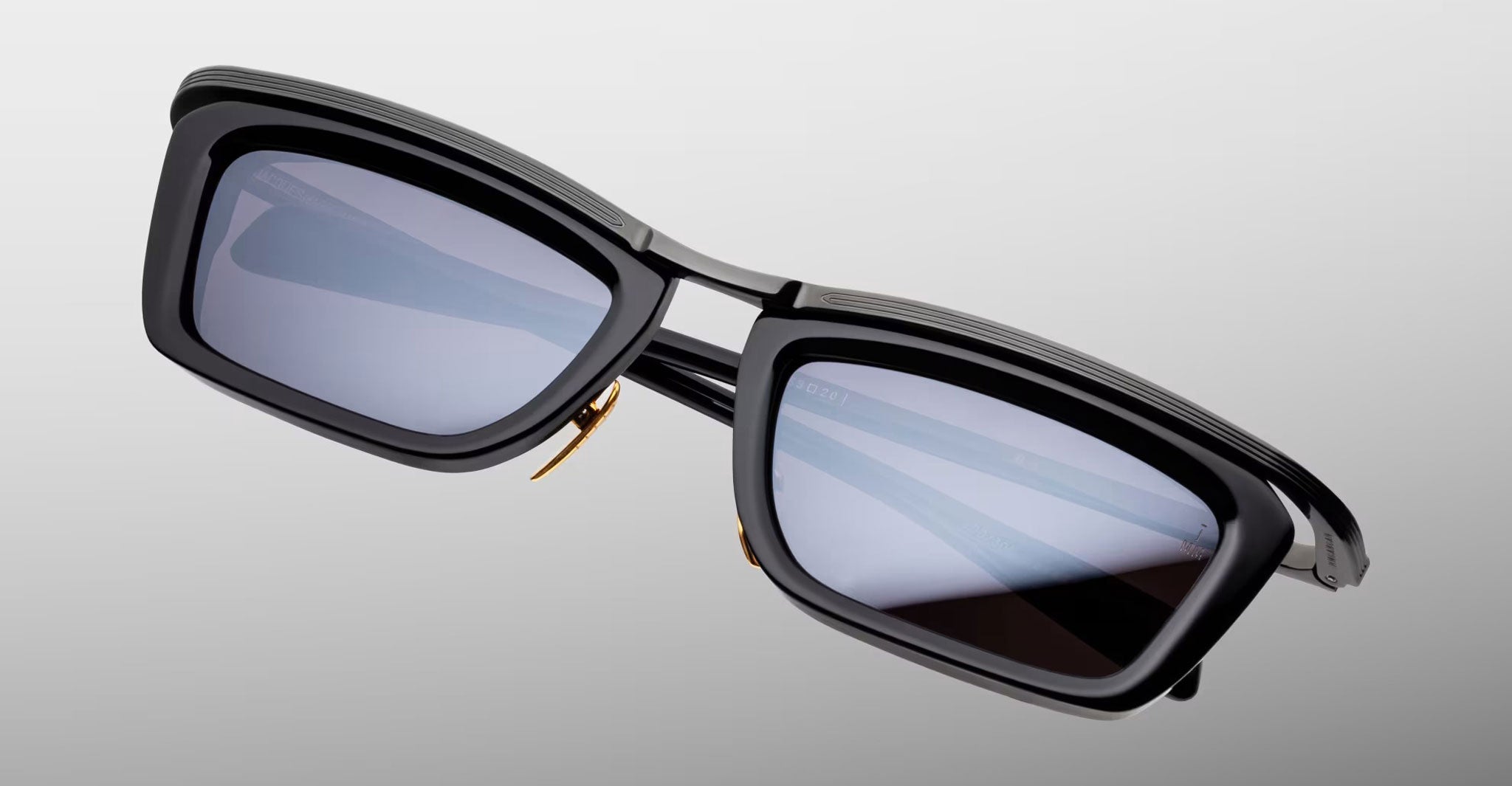 Jacques Marie Mage Gaspard black rectangular polarized sunglasses with dark lenses, front view.