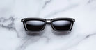 Jacques Marie Mage Gaspard black rectangular sunglasses with dark UV lenses, front view.
