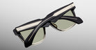 Jacques Marie Mage Hyannis in Black Fade sunglasses in black and taupe with green lenses, folded; modern design shown from a top-down back angle.