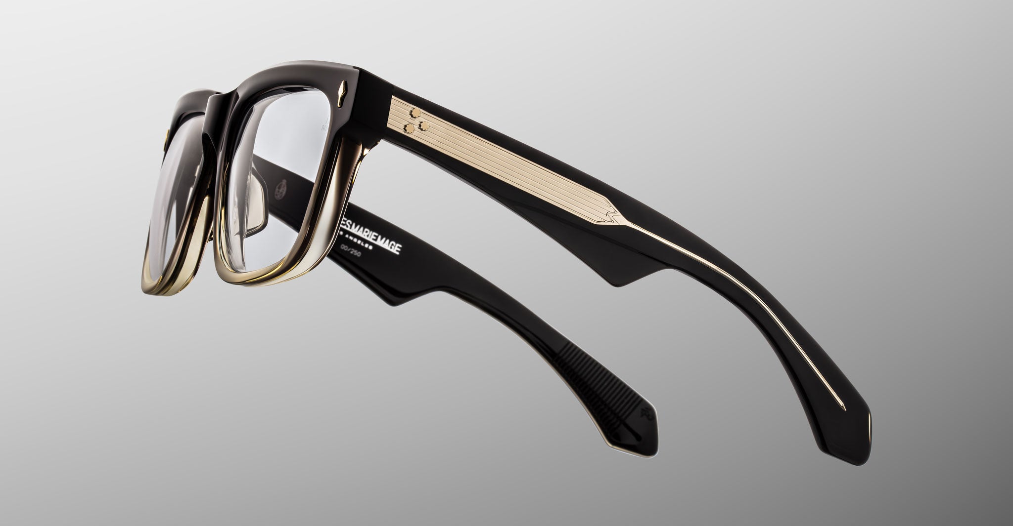 Jacques Marie Mage Hyannis in Black Fade black and taupe eyeglasses with clear lenses, modern design, side angled view.