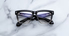 Jacques Marie Mage Hyannis in Black Fade black and gray square eyeglasses frame, front view, shown on flat surface.