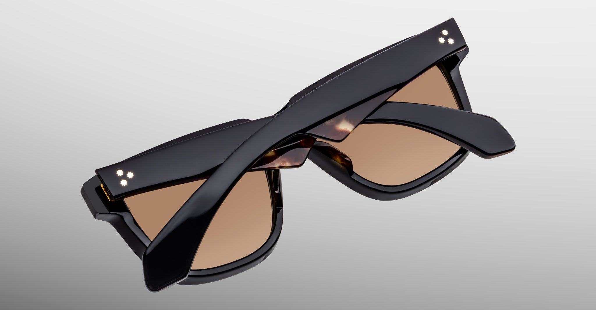 Jacques Marie Mage Hyannis in Noir 15 sunglasses, black frame with brown lenses, shown folded from a back angle.