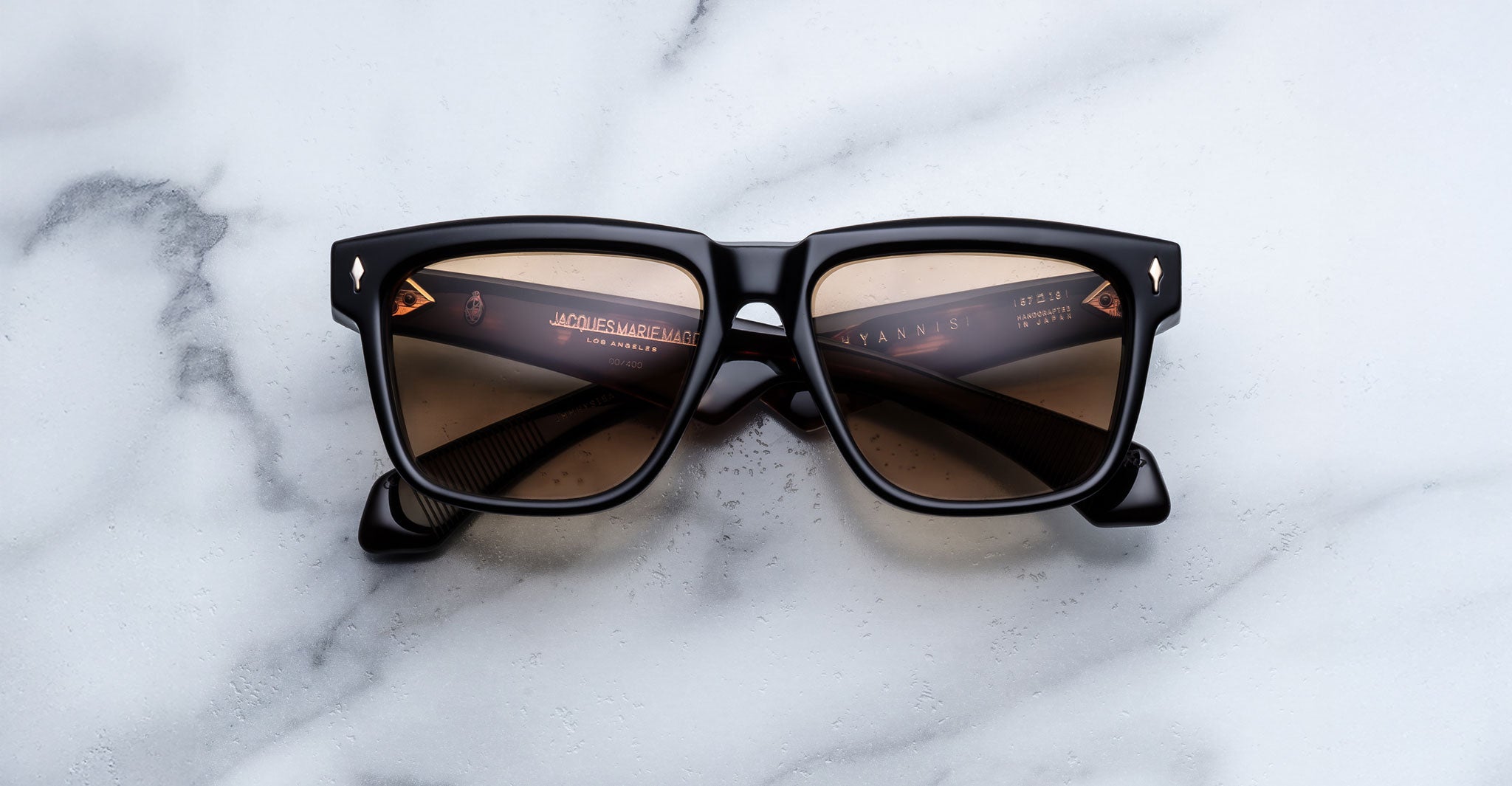 Jacques Marie Mage Hyannis in Noir 15 black square-frame sunglasses with brown lenses, top-view.